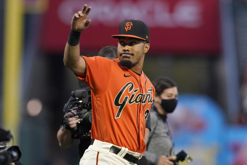 San Francisco Giants' LaMonte Wade Jr. waves as he is announced as the 2021 winner of The Willie Mac Award, named after former player Willie McCovey, before a baseball game between the Giants and the San Diego Padres in San Francisco, Friday, Oct. 1, 2021. (AP Photo/Jeff Chiu)