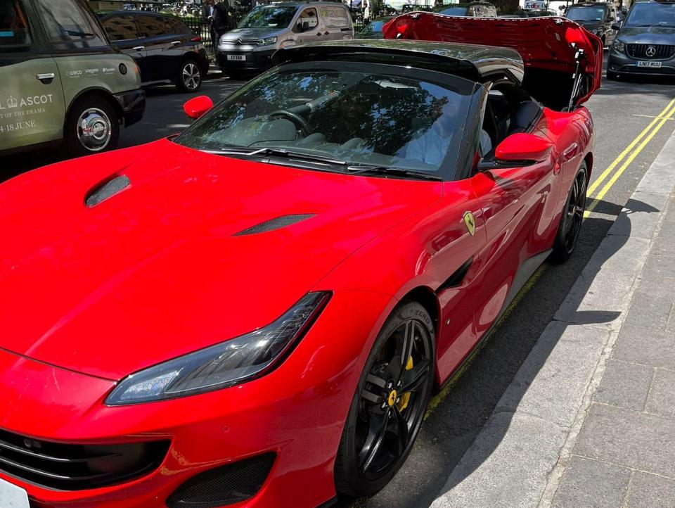 The Ferrari parked in London, and the hard top being opened.