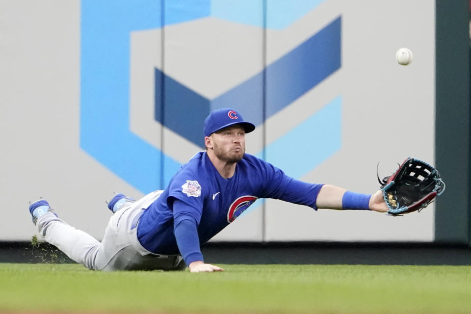 Chicago Cubs left fielder Ian Happ dives to stop a fly by St. Louis Cardinals' Juan Yepez for a single during the second inning of a baseball game Friday, June 24, 2022, in St. Louis. Happ was able to throw out Yepez at second on the play. (AP Photo/Jeff Roberson)