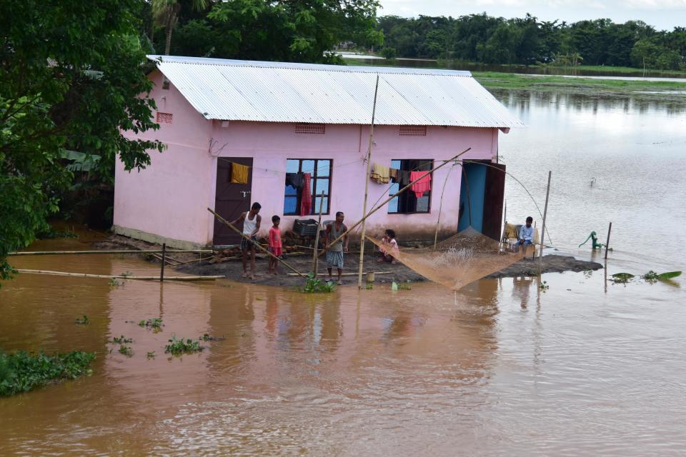 NAGAON,INDIA-JULY 22,2020 :A man casts his fishing net in the flood waters near his partially submerged hut at a village in Nagaon district of Assam ,India - PHOTOGRAPH BY Anuwar Ali Hazarika / Barcroft Studios / Future Publishing (Photo credit should read Anuwar Ali Hazarika/Barcroft Media via Getty Images)