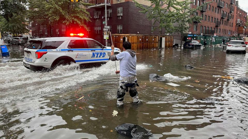 PHOTO: A man works to clear a drain in flood waters, Sept. 29, 2023, in the Brooklyn borough of New York. (Jake Offenhartz/AP)