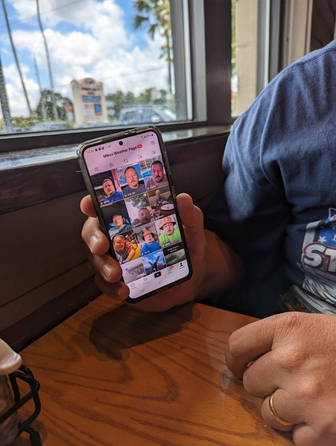 Mike Boylan of Mike’s Weather Page shows off his TikTok page at a Chili’s in Oldsmar, Florida. Boylan is prepping for tracking and chasing storms this hurricane season. Ryan Ballogg/rballogg@bradenton.com