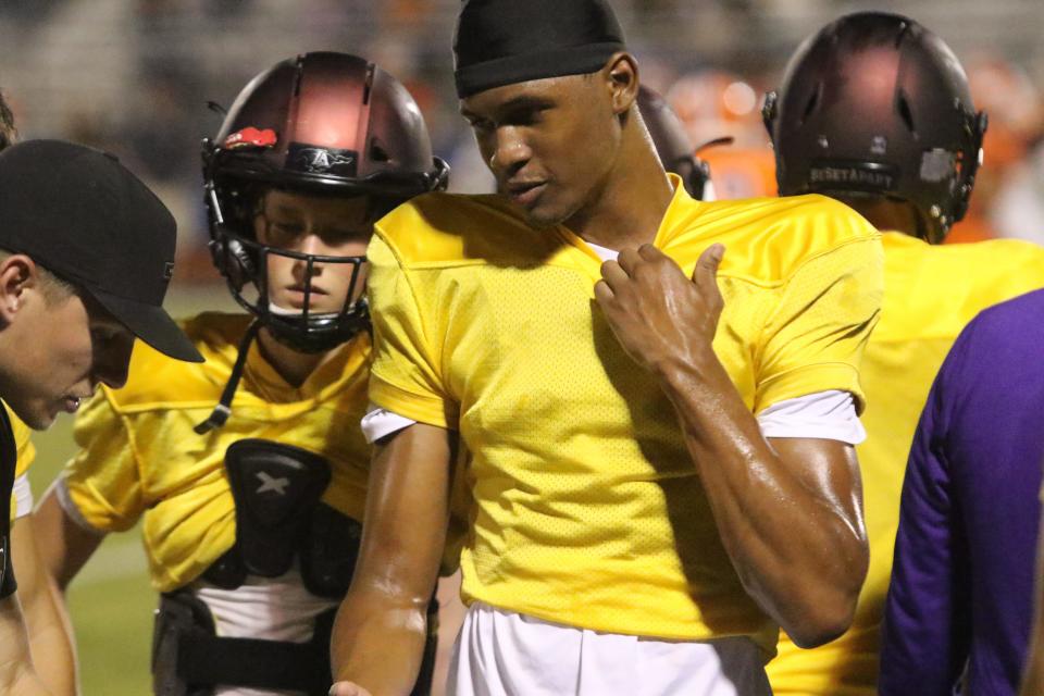 Lipscomb Academy junior quarterback Deuce Knight talks with position coaches on the sideline of their scrimmage against Blackman during the 615 Preseason Showcase Friday, August 11, 2023 at Oakland High School in Murfreesboro, Tennessee.