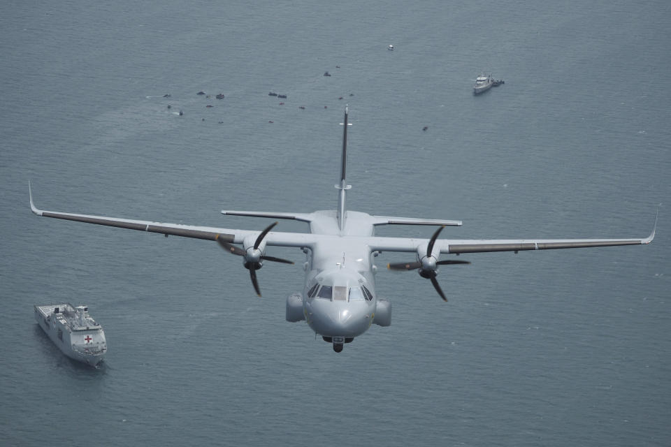 Indonesian Navy's aircraft flies as the search for the wreckage of a crashed Sriwijaya Air passenger jet continues, in this aerial photo taken over the Java Sea, off Jakarta, Indonesia, Tuesday, Jan. 12, 2021. Indonesian navy divers were searching through plane debris and seabed mud Tuesday looking for the black boxes of the Sriwijaya Air jet that nosedived into the Java Sea over the weekend with 62 people aboard. (AP Photo/Eric Ireng)