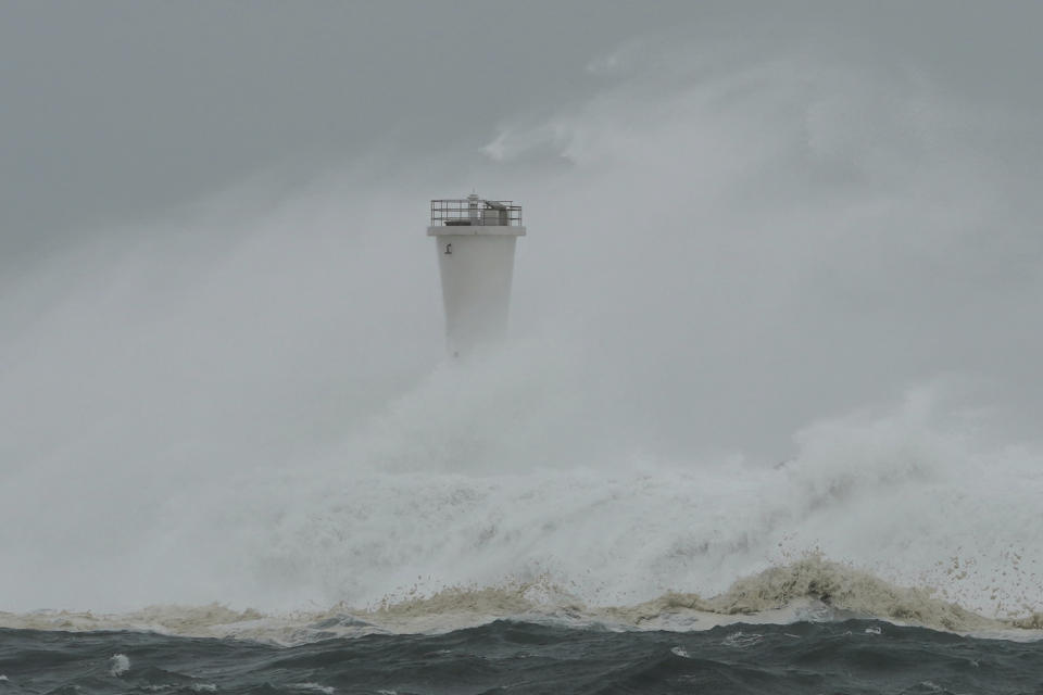 Surging waves hit against the breakwater and a lighthouse as Typhoon Hagibis approaches at a port in town of Kiho, Mie prefecture, central Japan Saturday, Oct. 12, 2019. Tokyo and surrounding areas braced for a powerful typhoon forecast as the worst in six decades, with streets and trains stations unusually quiet Saturday as rain poured over the city. (AP Photo/Toru Hanai)