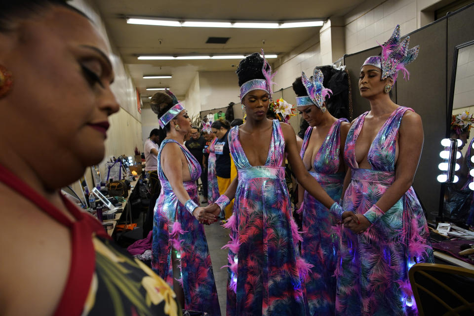 Performers, including Chevis Regal, center, hold hands before performing in the Mahu Magic drag show at the Western Regional Native Hawaiian Convention, Tuesday, June 20, 2023, in Las Vegas. (AP Photo/John Locher)