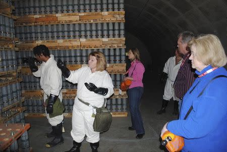 Irene Kornelly (R), chairperson of the Colorado Citizen’s Advisory Commission, is briefed on the storage of mustard-filled 105mm projectiles inside a chemical storage igloo, along with staff of the Colorado Department of Public Health and Environment in an undated photo provided by the U.S. Army Chemical Materials Activity (CMA) in Pueblo, Colorado. REUTERS/U.S. Army Chemical Materials Activity/Handout via Reuters