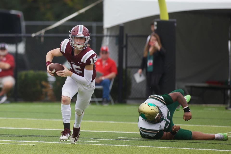 First Baptist quarterback Ethan Crossan runs during the 1S state title game against Trinity Catholic.