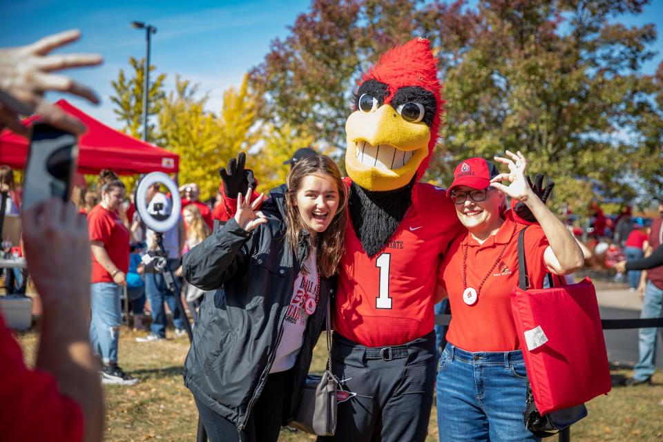 Charlie The Cardinal frolics with revelers at pre-homecoming event.