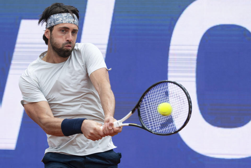 Nikoloz Basilashvili of Georgia returns the ball to Jan-Lennard Struff of Germany during his tennis ATP final match in Munich, Germany, Sunday, May 2, 2021. (Sven Hoppe/dpa via AP)