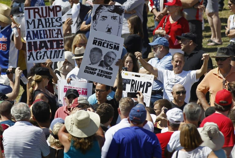 Protesters filter into the crowd of Trump supporters during a campaign rally at Fountain Park on March 19, 2016 in Fountain Hills, Arizona