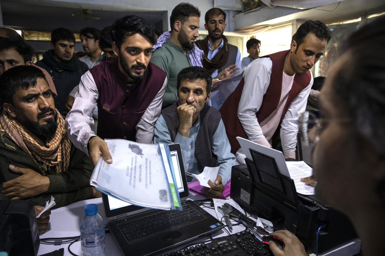 Afghan Afghan Special Immigrant Visa (SIV) applicants crowd into the Herat Kabul Internet cafe seeking help applying for the SIV program on August 8, 2021 in Kabul, Afghanistan. Thousands of Afghans who worked for the United States government during its nearly 20-year war here now fear for their safety as the US withdraws its troops from the country.  (Paula Bronstein/Getty Images)