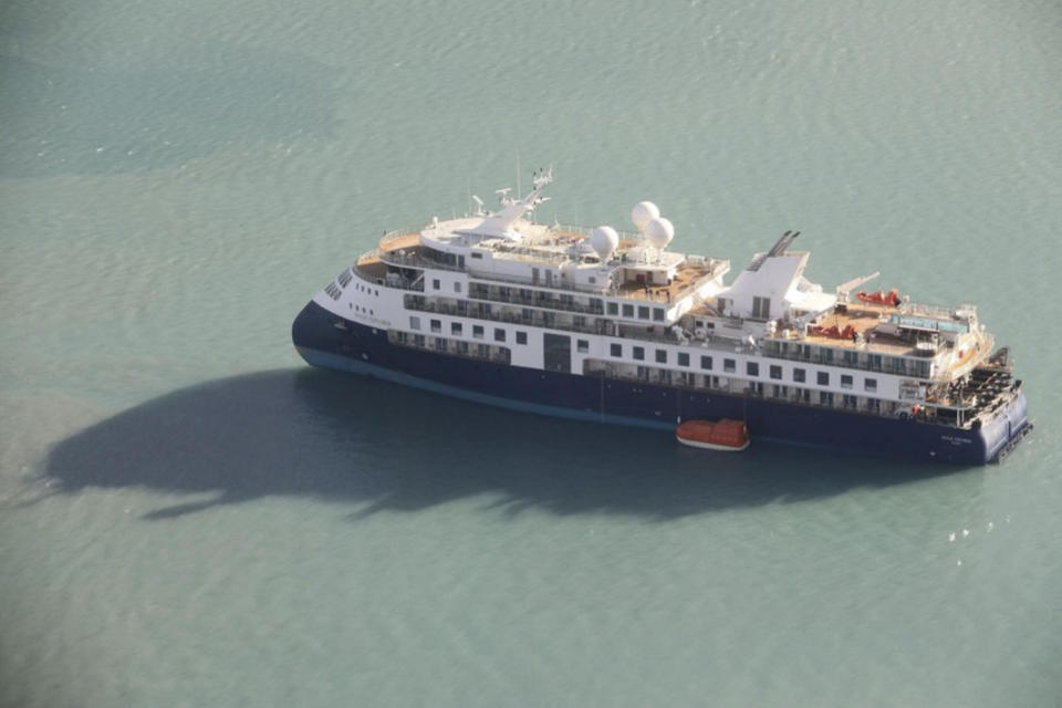 An aerial photo shows the Ocean Explorer, a Bahamas-flagged Norwegian cruise ship with 206 passengers and crew, which has run aground in northwestern Greenland, on Tuesday, Sept. 12, 2023. The 104.4-meter (343-foot) long and 18-meter (60 foot) wide Ocean Explorer ran aground on Monday in Alpefjord in the Northeast Greenland National Park. It's the world’s largest and most northerly national park and is known for icebergs and the musk oxen that roam the coast. According to authorities no one on board was in danger and no damage has been reported. (Danish Air Force/Joint Arctic Command via AP)
