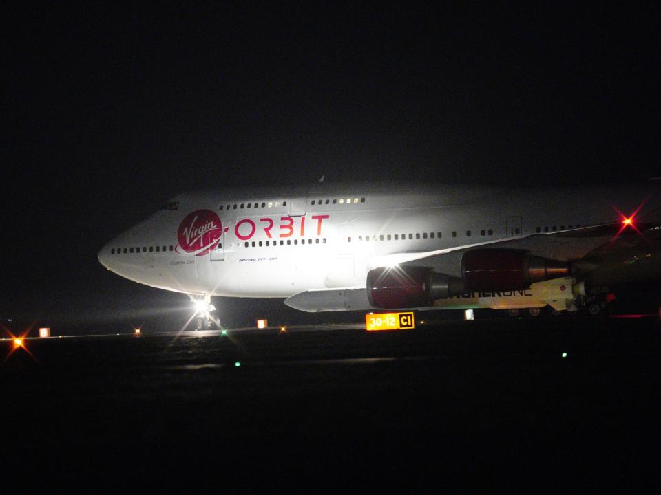 A repurposed Virgin Atlantic Boeing 747 aircraft, named Cosmic Girl, carrying Virgin Orbit's LauncherOne rocket, taxis down the runway ahead of take off at Spaceport Cornwall at Cornwall Airport, Newquay.