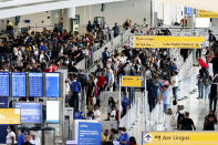 People wait in a TSA line at the John F. Kennedy International Airport on Tuesday, June 28, 2022, in New York. (AP Photo/Julia Nikhinson)