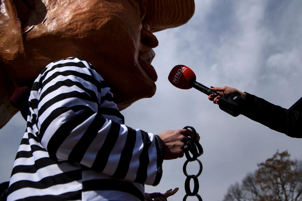 An activist dressed as an of effigy of US President Donald Trump is interviewed while protesting during Presidents' Day in Lafayette Square near the White House on Feb. 18, 2019 in Washington, D.C. (Photo: Brendan Smialowski/AFP/Getty Images)