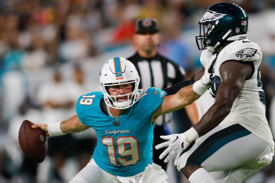 Dolphins quarterback Skylar Thompson tries to fend off Eagles linebacker Byron Johnson.