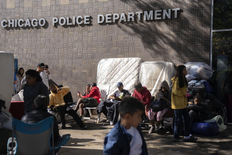 Migrants are camped outside of the 1st District police station, Saturday, Oct. 7, 2023, in Chicago. (AP Photo/Erin Hooley)