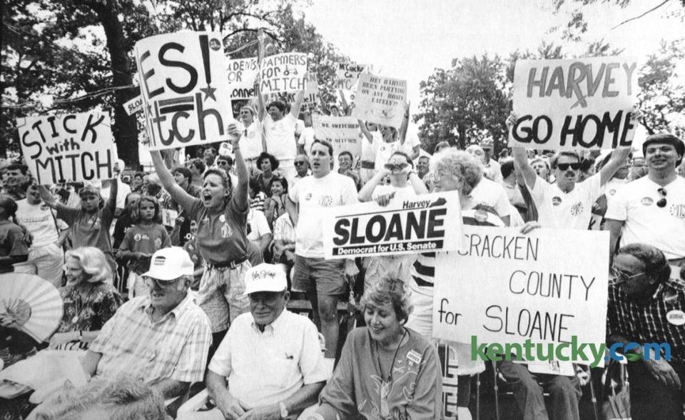 Backers of U.S. Sen. Mitch McConnell and his Democratic opponent, Harvey Sloane, made their loyalties known during Gov. Wallace Wilkinson’s speech at the 1990 Fancy Farm picnic.