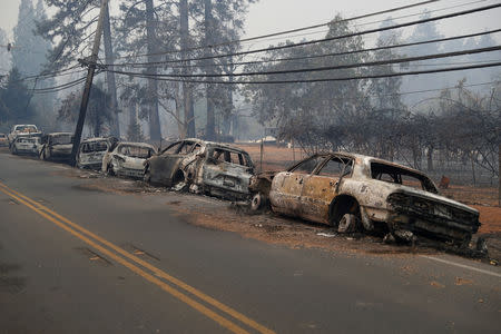A row of burned vehicles are seen on Skyway during the Camp Fire in Paradise, California, U.S. November 9, 2018. REUTERS/Stephen Lam