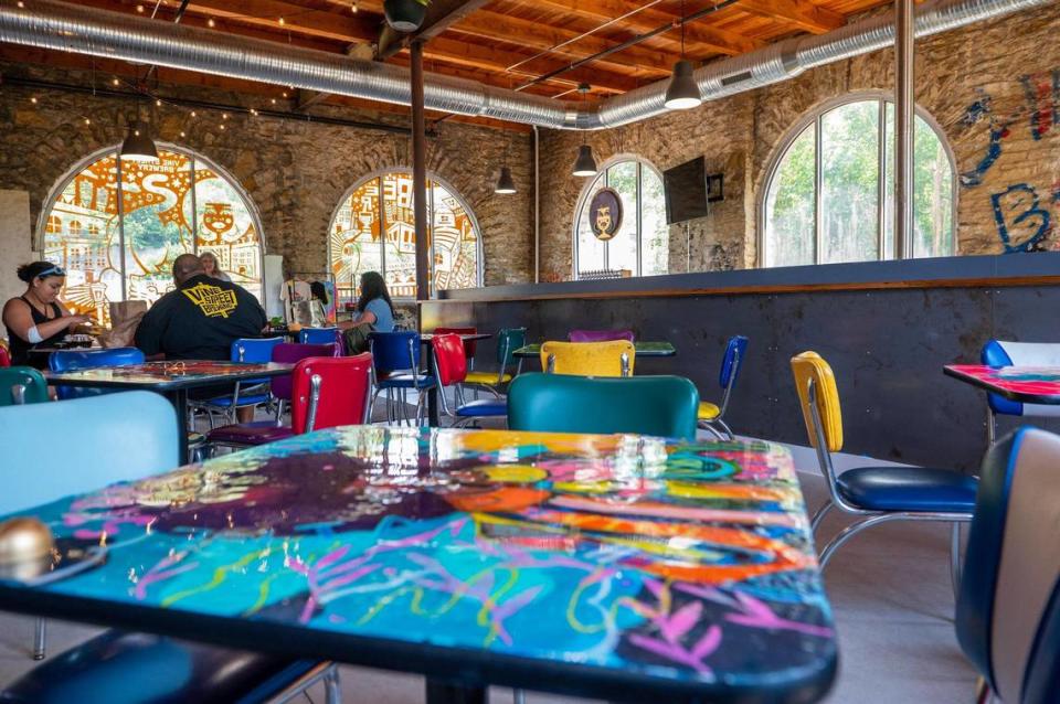 Paintings by local artist Warren Harvey line the walls, and tabletops are adorned with custom paintings from Jessie Green at Vine Street Brewing Co.