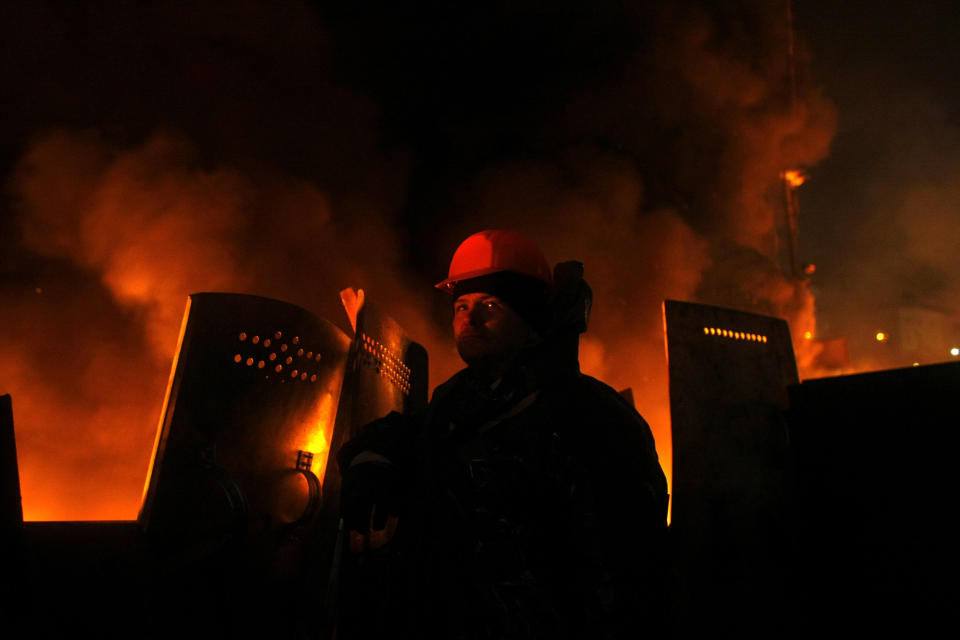 An anti-government protester mans a barricade at Independence Square in Kiev, Ukraine, Thursday, Feb. 20, 2014. Ukraine's protest leaders and the president they aim to oust called a truce Wednesday, just hours after the military raised fears of a widespread crackdown with a vow to defeat "terrorists" responsible for seizing weapons and burning down buildings. (AP Photo/ Marko Drobnjakovic)