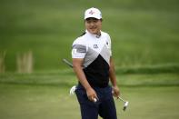 K.H. Lee, of South Korea, smiles as he walks off after his putt on the 18th green during the first round of the Wells Fargo Championship golf tournament, Thursday, May 5, 2022, at TPC Potomac at Avenel Farm golf club in Potomac, Md. (AP Photo/Nick Wass)