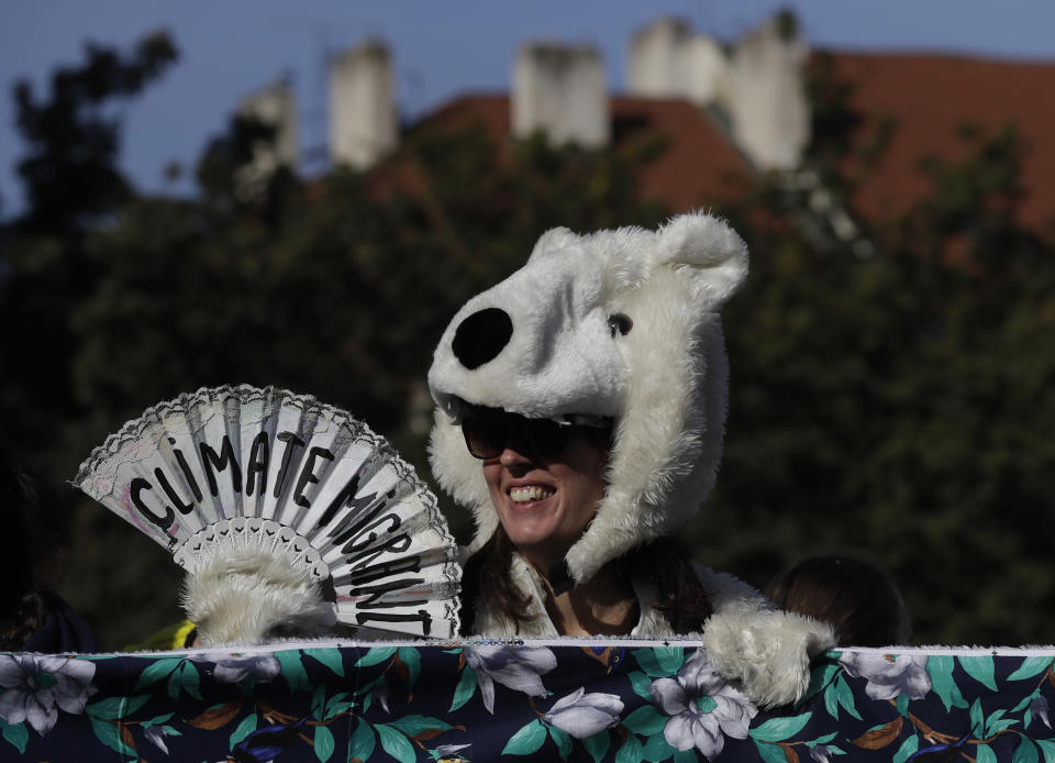 A girl wearing a polar bear costume joins a protest at the Old Town Square in Prague, Czech Republic, Friday, Sept. 20, 2019. Several hundreds of protestors gathered in response to a day of worldwide demonstrations calling for action to guard against climate change. (AP Photo/Petr David Josek)