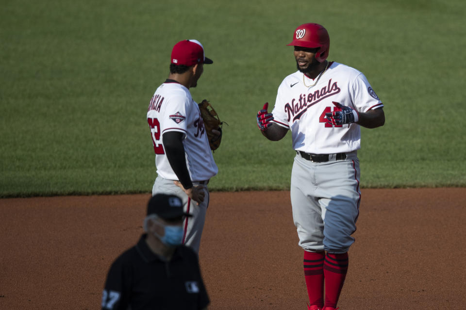 Washington Nationals shortstop Luis Garcia, left, talks with Howie Kendrick as he stands on second base during a baseball intrasquad game at Nationals Park, Thursday, July 16, 2020, in Washington. (AP Photo/Alex Brandon)