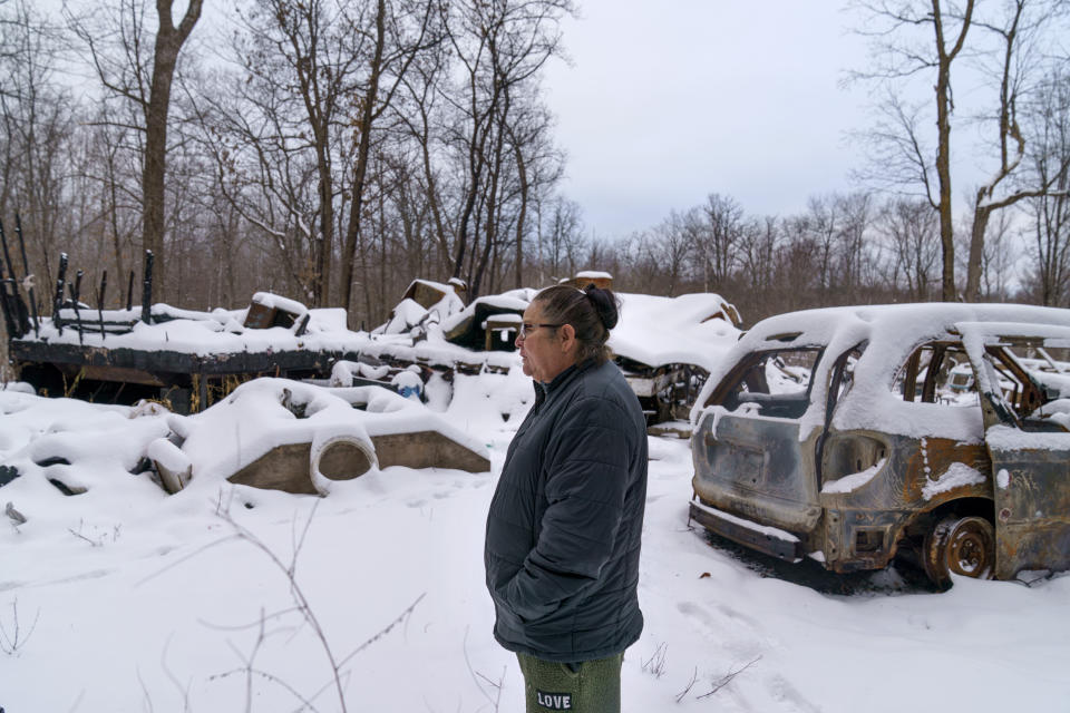 Betty Oppegard visits the site of a burned down trailer where her daughter, Beth Renee Hill, died of an overdose involving methamphetamine, in Naytahwaush, Minn., Thursday, Nov. 18, 2021. Hill's Indian name was the Ojibwe word for how snow sparkles in the sunshine. "She was like that, she sparkled in people's lives, she was so beautiful," said Oppegard. "She could make a lot happen in a day." (AP Photo/David Goldman)