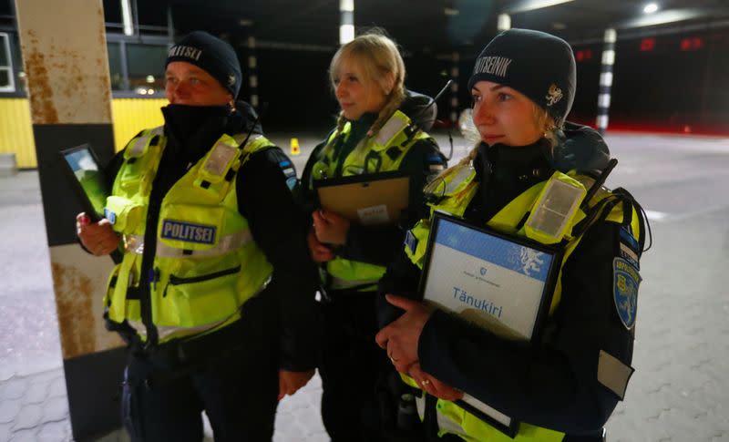 Estonian police and border guard officers hold diplomas at border crossing point in Ikla