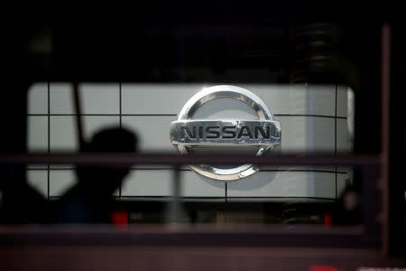 The logo of Nissan is seen through a window of a bus passing by its dealership in Seoul, South Korea, May 16, 2016. REUTERS/Kim Hong-Ji/File Photo