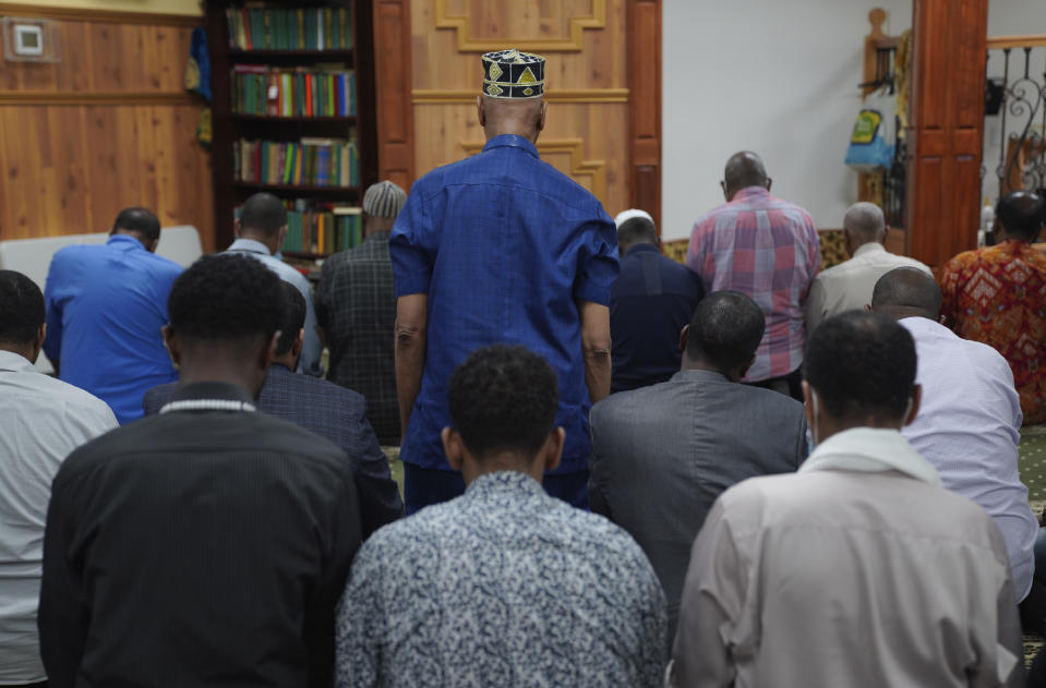 Members of the Abubakar As-Saddique Islamic Center kneel during afternoon prayer on Thursday, May 12, 2022, in Minneapolis. This spring Minneapolis became the first large city in the United States to allow the Islamic call to prayer, or adhan, to be broadcast publicly by its two dozen mosques. (AP Photo/Jessie Wardarski)