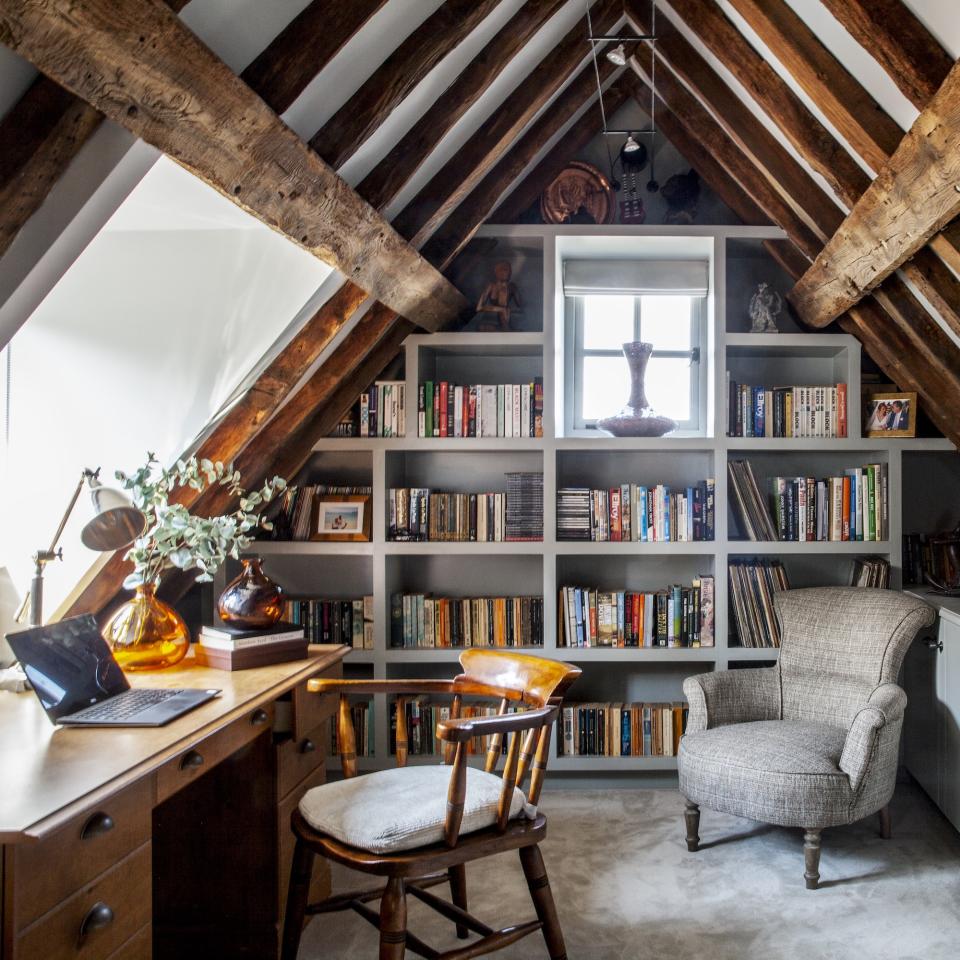 loft office with bookshelves and antique desk