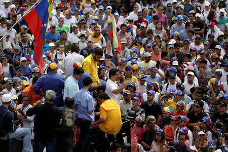 Lawmaker Freddy Guevara (C) addresses demonstrators during a rally against Venezuela's President Nicolas Maduro in Caracas, Venezuela April 24, 2017. REUTERS/Marco Bello