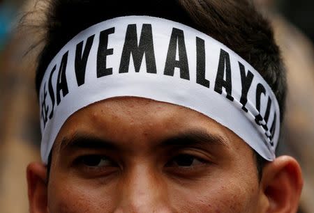 A student activist wearing a message on his headband prepares to march towards Dataran Merdeka, or Independence Square, to call for the arrest of "Malaysian Official 1" in Kuala Lumpur, Malaysia August 27, 2016. REUTERS/Edgar Su