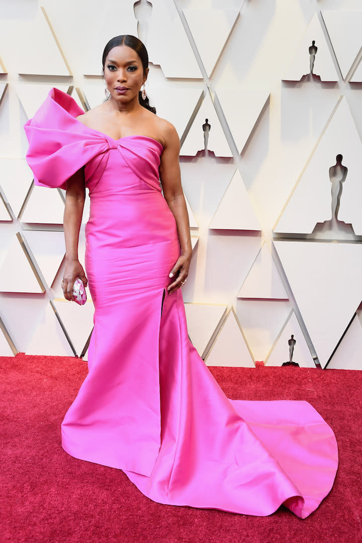 Proving once again that pink is best left to the grown-ups, 60-year-old Angela Bassett looked incredible in a one-shoulder Reem Acra gown at the 2019 Academy Awards. It's just another one of her bold outfit choices to add to our 'saved' category on Instagram. <em>[Photo: Getty]</em>