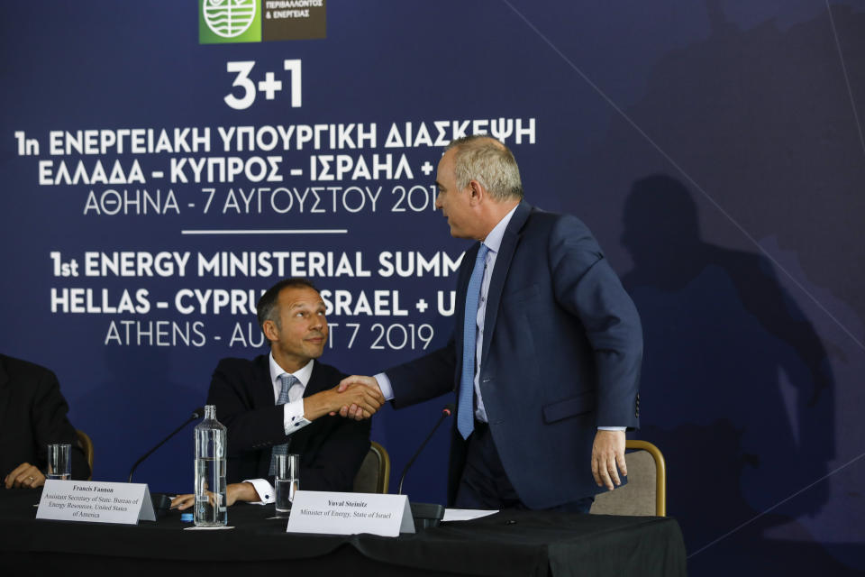 Israel's Energy Minister Yuval Steinitz, right, shakes hands with U.S. Assistant Secretary of State of Energy Francis Fannon during a summit in Athens, on Wednesday, Aug. 7, 2019. Ministers of Greece , Cyprus Israel and US participated Wednesday in the first Energy Ministerial Summit. (AP Photo/Petros Giannakouris)