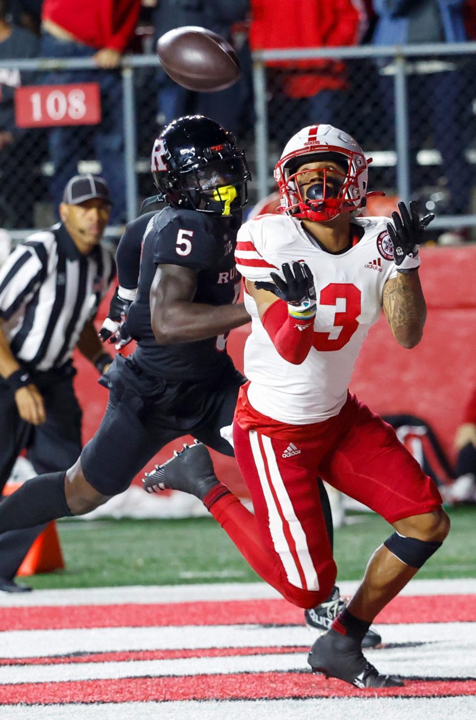 Rutgers defensive back Kessawn Abraham, left, watches Nebraska wide receiver Trey Palmer (3) catch a pass for a touchdown during the fourth quarter of an NCAA college football game Friday, Oct. 7, 2022, in Piscataway, N.J. (Andrew Mills/NJ Advance Media via AP)