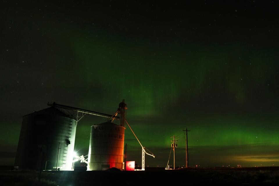 An aurora borealis, also known as the northern lights, is seen in the night sky on Sunday, Feb. 26, 2023, next to grain elevators near Washtucna, Wash.