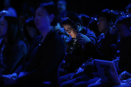 Members of the media and analysts listen to translations while working at a LeEco press event in San Francisco, California, U.S. October 19, 2016. RETUERS/Beck Diefenbach