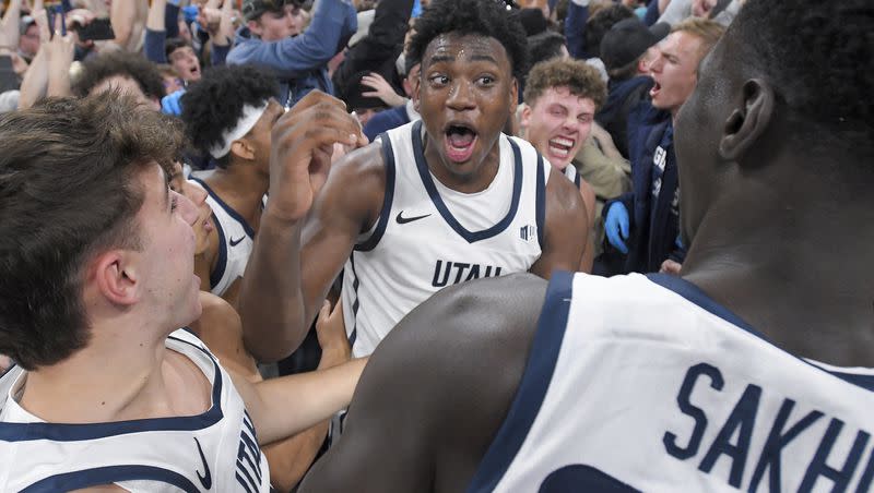Utah State forward Great Osobor, center, celebrates with players and fans after the team’s win over Colorado State in an NCAA college basketball game Saturday, Jan. 6, 2024, in Logan, Utah. (Eli Lucero/The Herald Journal via AP)