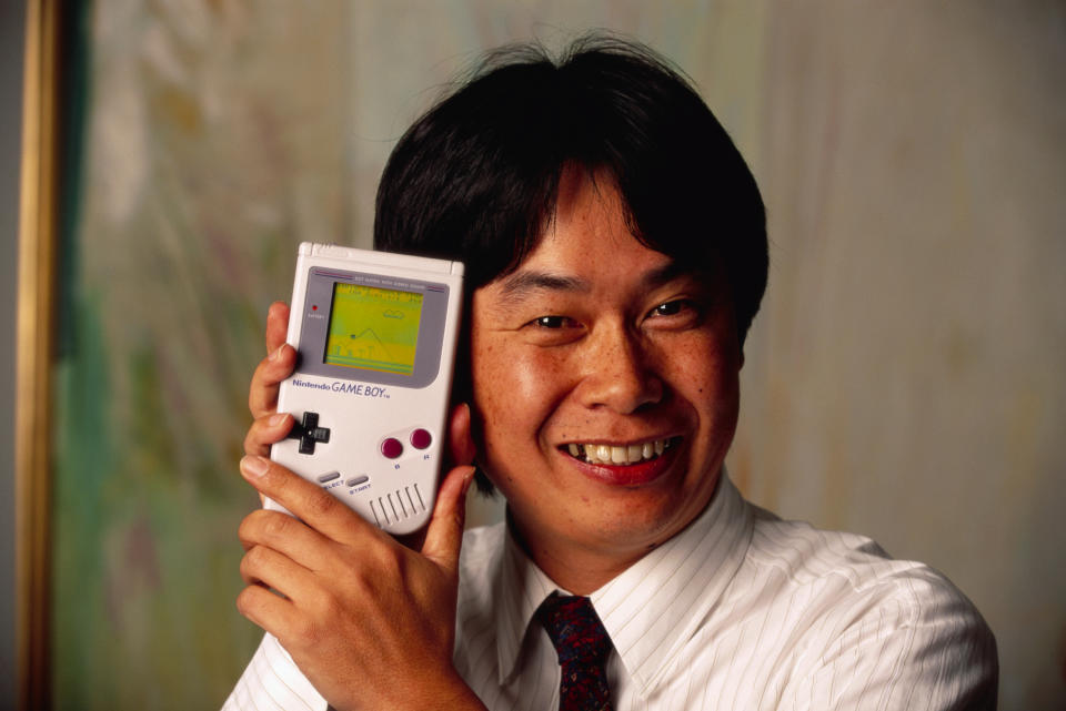 Shigeru Miyamoto, creator of Mario and other characters and video games for Nintendo, holds a Nintendo Game Boy containing the Super Mario World video game. (Photo by © Ralf-Finn Hestoft/CORBIS/Corbis via Getty Images)