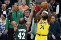 Los Angeles Lakers' Patrick Beverley (21) shoots against Boston Celtics' Al Horford (42) during the first half of an NBA basketball game, Saturday, Jan. 28, 2023, in Boston. (AP Photo/Michael Dwyer)