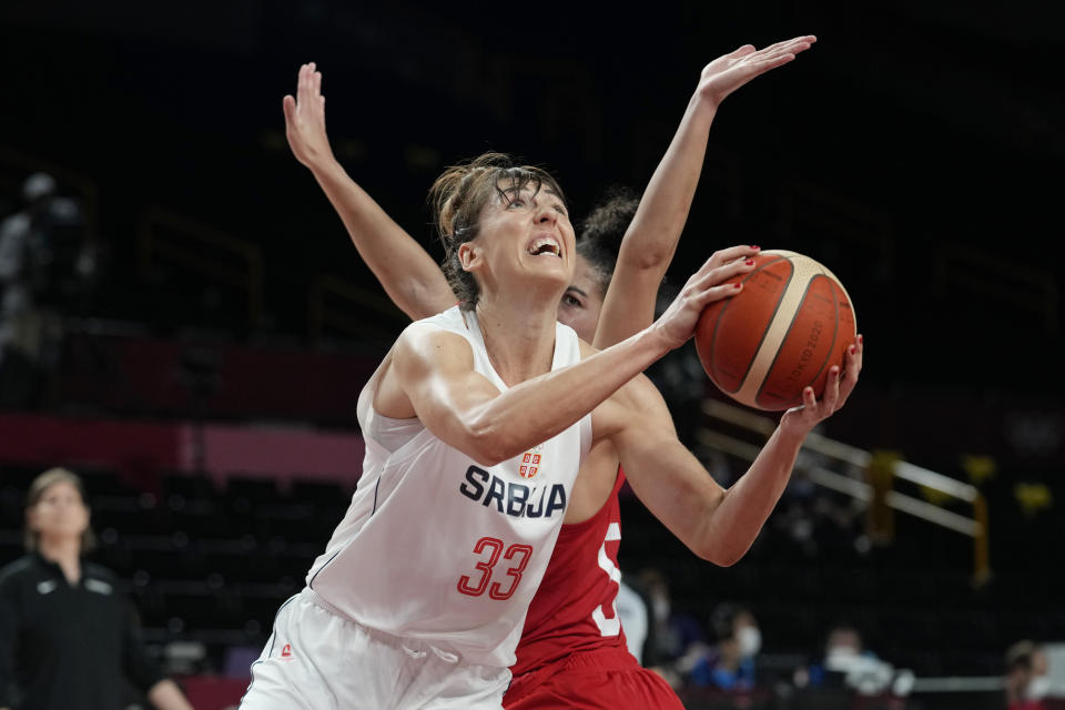 FILE - Serbia's Tina Krajisnik (33) drives around Canada's Kia Nurse (5) during a women's basketball game at the 2020 Summer Olympics, Monday, July 26, 2021, in Saitama, Japan. Krajisnij is a 31-year-old rookie on the WNBA Chicago Sky. (AP Photo/Eric Gay, File)