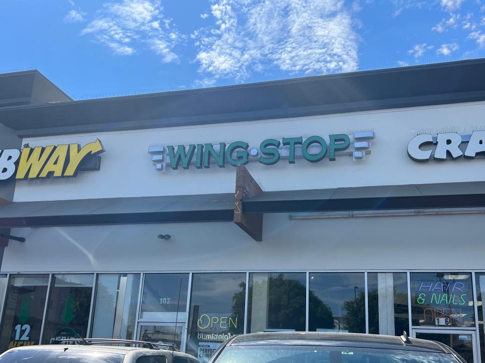 Wingstop store on a strip next to Subway