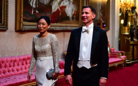 Britain's Foreign Secretary Jeremy Hunt and his wife Lucia arrive  - Credit: Victoria Jones / POOL / AFP