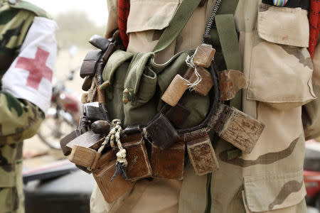 A Chadian soldier wears charms for protection near the front line during battle against insurgent group Boko Haram in Gambaru, February 26, 2015. REUTERS/Emmanuel Braun