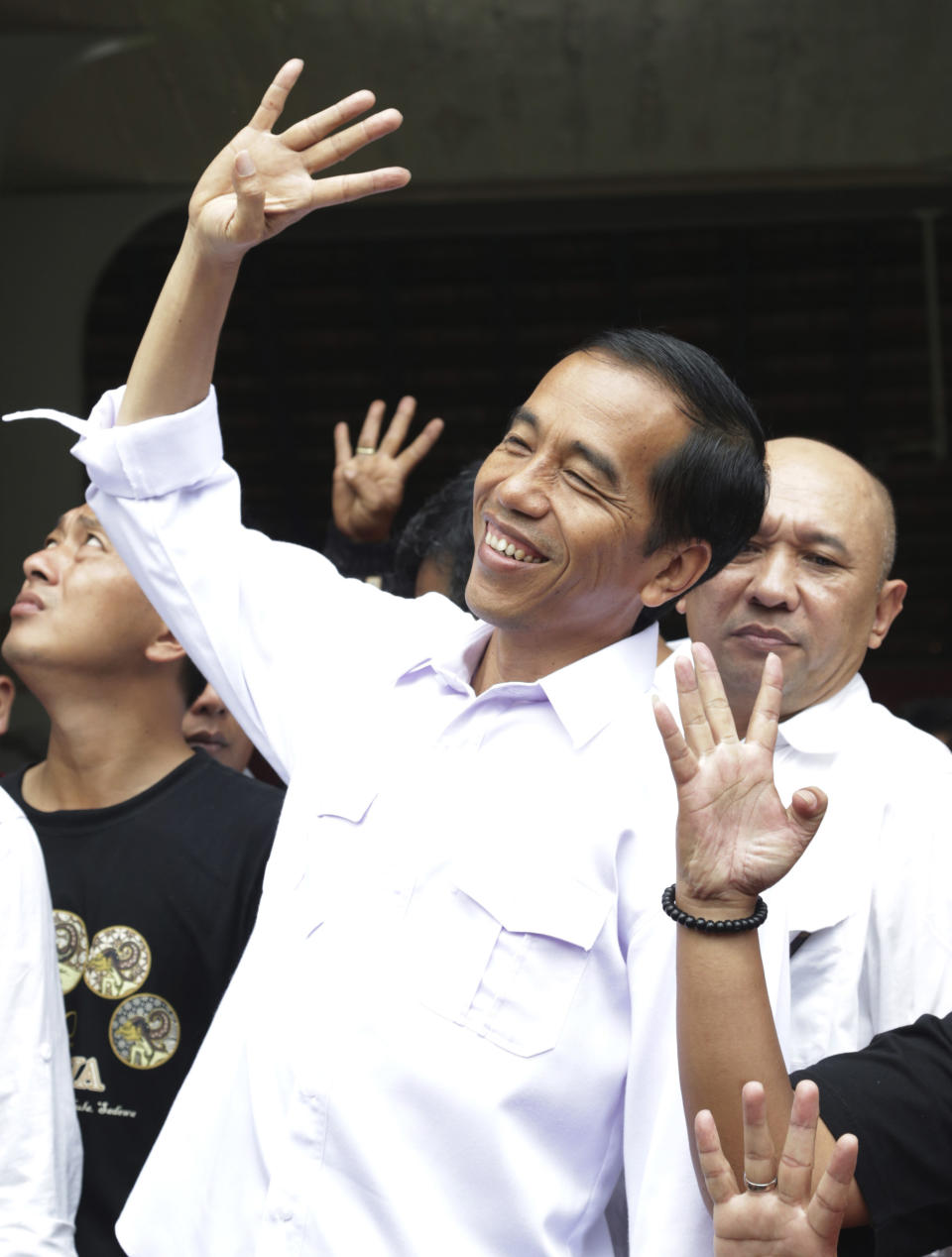 In this Sunday, March 16, 2014 photo, Indonesian presidential candidate Joko Widodo gestures during a campaign rally in Jakarta, Indonesia. Jakarta Gov. Joko Widodo, known affectionately as Jokowi, has attracted legions of supporters, especially among the young, igniting the same type of hunger for change that galvanized many previously apathetic American voters to turn out for Barack Obama in 2008. The soft-spoken former furniture producer wears simple button-down shirts with no tie or jacket and has developed a reputation of getting up close and personal with the capital’s poor, from wading into floodwaters to visiting slums. (AP Photo/Achmad Ibrahim)