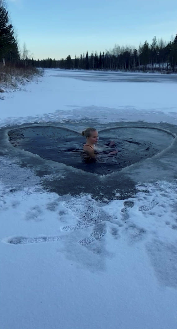 A woman has gone viral for jumping into lakes in a swimming costume in temperatures of -20°C. (SWNS)